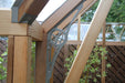 Close-up of corner structural detail in the Alton Cambridge Cedar Greenhouse with elegant metal supports.