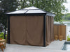 A Venus Gazebo 10x10 with its privacy curtains fully drawn, creating a closed-off space on a deck next to a pool, with trees in the background.