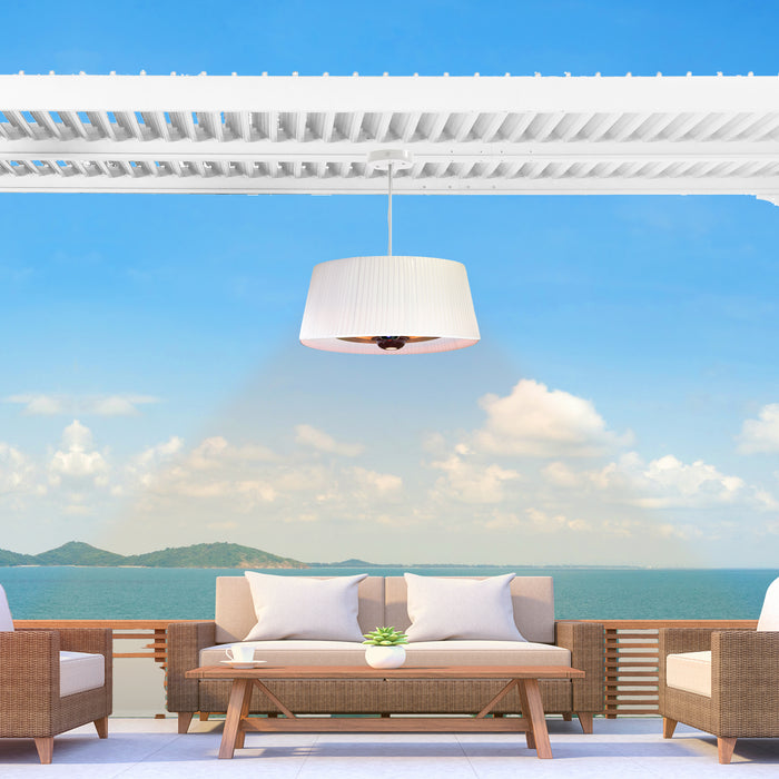 A sleek white Sol Pendant Electric Heater offers a cozy atmosphere on a beachfront patio, enhancing the modern outdoor dining experience.