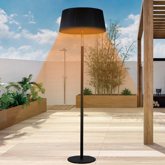  The Sol heater stands in a sunlit outdoor setting, casting a warm glow on the tiled floor, demonstrating its use during the day.