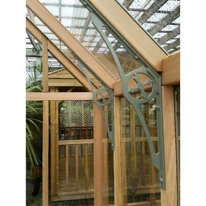 Intricate green decorative braces supporting the Alton Lancing Greenhouse frame.