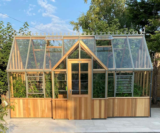 Decorative Alton Cedar Structure Cambridge Greenhouse showcasing its wooden frame and intricate glass panels.