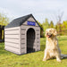 Golden Retriever sitting beside the Duramax Outdoor Pet Kennel labeled "Best Dog Ever" in an outdoor garden setting.