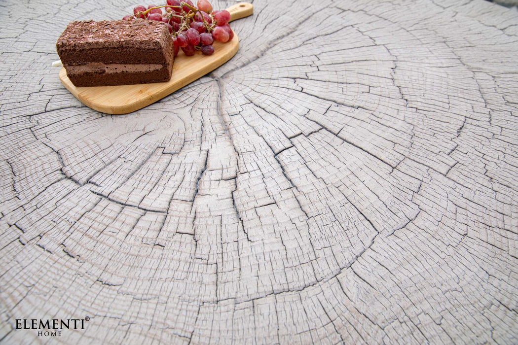 Close-up of the Elementi Daintree drift wood large coffee table with a cake and grape platter on its textured surface.