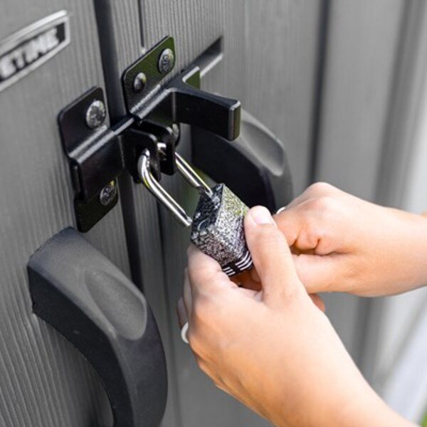Close-up of a padlock securing the Lifetime dual entry storage shed's slider latch door handles.