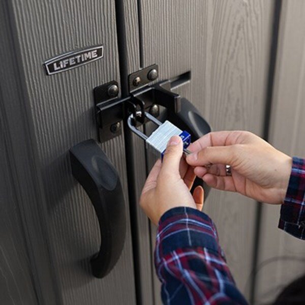 Close-up of a padlock securing the Lifetime dual entry storage shed's slider latch door handles.