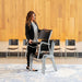 Person stacking Lifetime 14 Pack Stacking Chair using built in carry handle for convenient storage