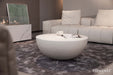 Elementi Chronos Series medium coffee table in cream white, placed in a contemporary living room with soft furnishings.