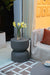 Elementi Chronos Series large side table in slate black, styled outdoors near a sofa and accent decor.