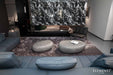 Elementi Hawaii Pebble Table in Moon Grey placed in a modern living room setting with sofas.