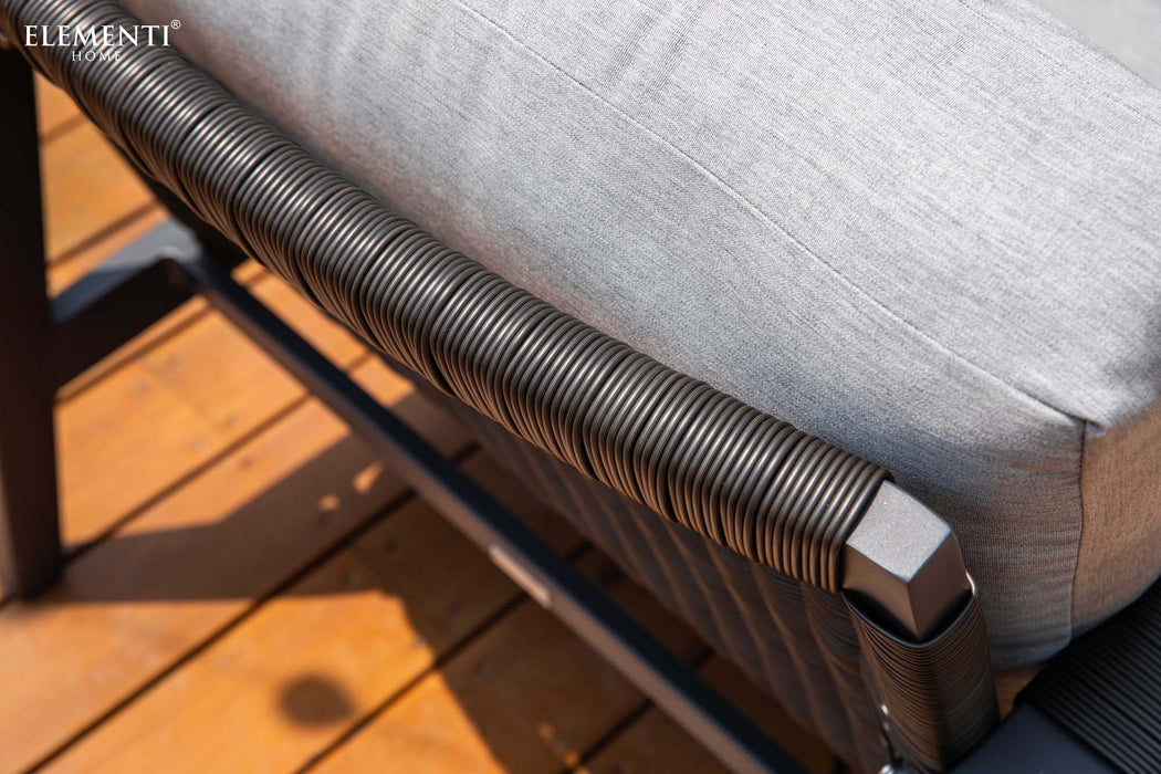 Detailed shot of the woven armrest of a chair from the Elementi Home Laguna Collection, showcasing the durable and stylish design.