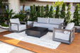 Complete Elementi Outdoor Furnitures Newport Collection set including a sofa, two armchairs, and a central table on a wooden deck.