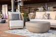 Single lounge chair from Malibu Collection by Elementi Outdoor Furnitures, paired with a round coffee table and soft cushions 
