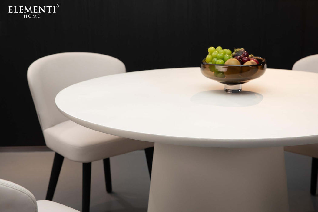 Elementi Rio Dining Table in cream white, close-up shot showcasing the table's smooth surface with a centerpiece of fruits.