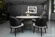 Elementi Rio Large Dining Table in space grey, styled in a contemporary dining room setup with black and grey chairs and a floral centerpiece.