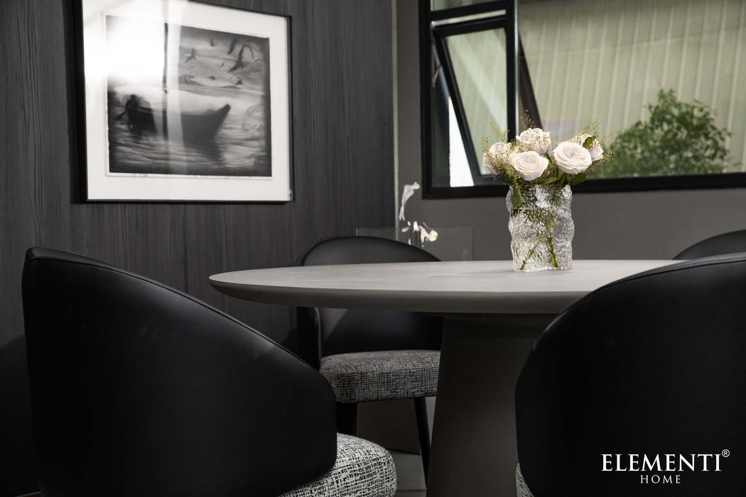 Elementi Rio Large Dining Table in space grey, close-up shot highlighting the texture and design surrounded by chairs.