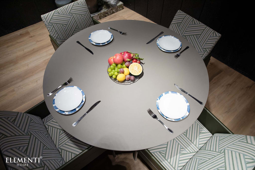 Elementi Rio Dining Table in space grey, top-view shot showing the table set for dining with a centerpiece of fruits and tableware.