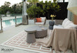 Elementi Rome Space Grey Large Coffee Table with small side table used in a poolside setup, adding a touch of sophistication to the outdoor space.