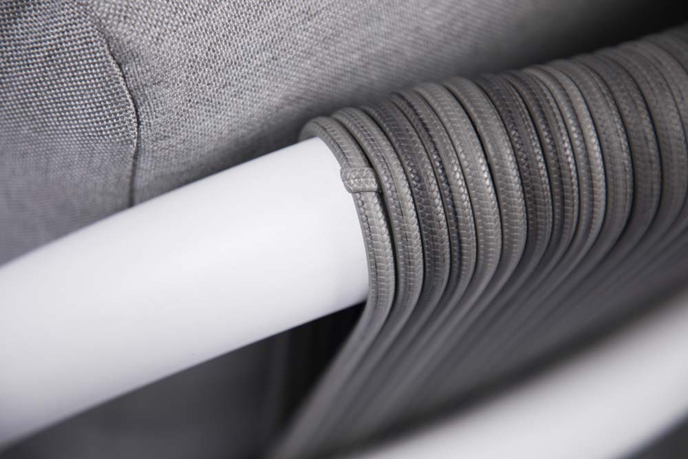 A detailed close-up of gray woven rope wrapping around a white frame, showcasing a design element of the Elementi Santorini Collection.