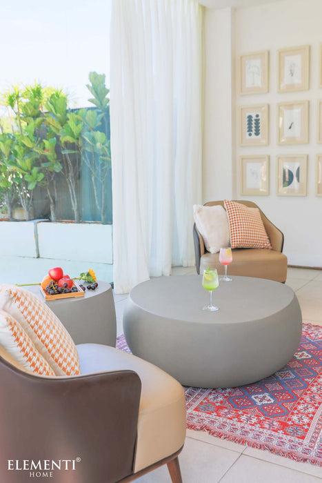 Stylish indoor lounge setup with the Elementi Space Grey Coffee Table, armchairs, and decorative items.