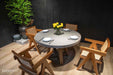 Elementi Verona Dining Table in space grey, styled in a dining room setting with wooden chairs and a decorative plant.