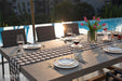 Seine Dining Table Series rectangular dining table set for an outdoor dinner by the pool during sunset, showcasing its elegant versatility.