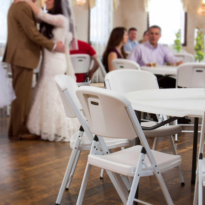 Lifetime 4 Pack White Classic Folding Chair used for indoor reception seating with round tables