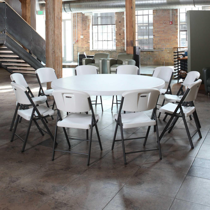 Lifetime 4 Pack 72in Round Table arranged with white folding chairs in modern indoor event space