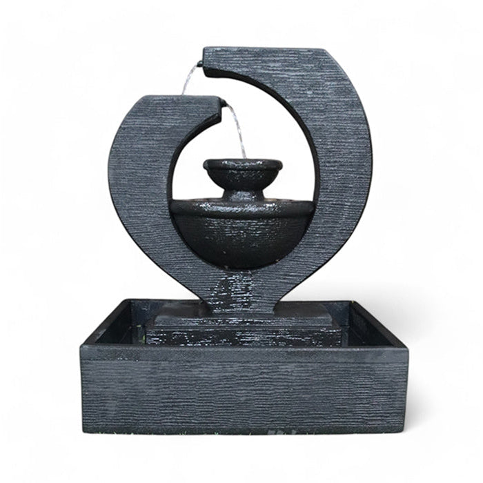 Exaco Eclipse Fountain in black, a modern tabletop water feature with a two-tiered design, perfect for creating a calming atmosphere in both indoor and outdoor spaces.