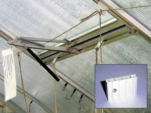 Riga greenhouse ceiling with plastic hooks installed in the frame channel, supporting ropes for vining plants.