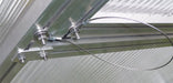 Close-up of Exaco greenhouse window lock safety cable fixed to frame bolts, designed to secure windows and prevent damage during storms.