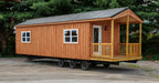 Side view of the Firestack Cabin displaying the 2 windows, a door, and a porch.