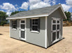 Riverside garden shed on a display lot painted dark gray with transom windows