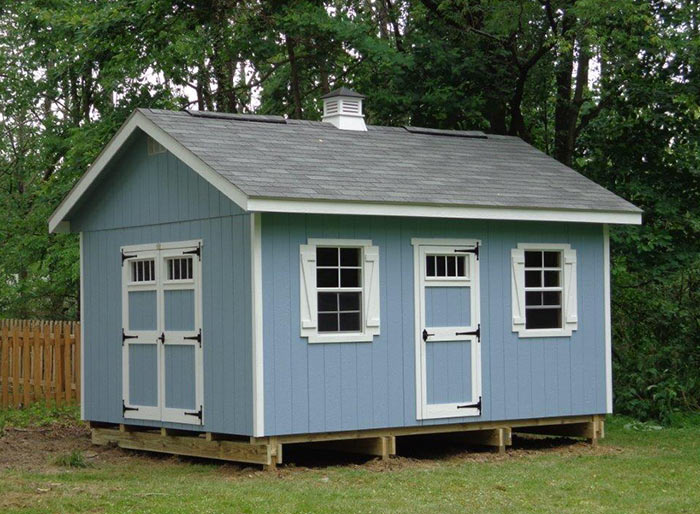 ez fit sheds riverside outdoor shed in a backyard painted in blue with a cupola