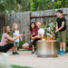 Family toasting marshmallows over the Solo Stove Yukon + Stand 2.0 smokeless fire pit, creating memorable moments.