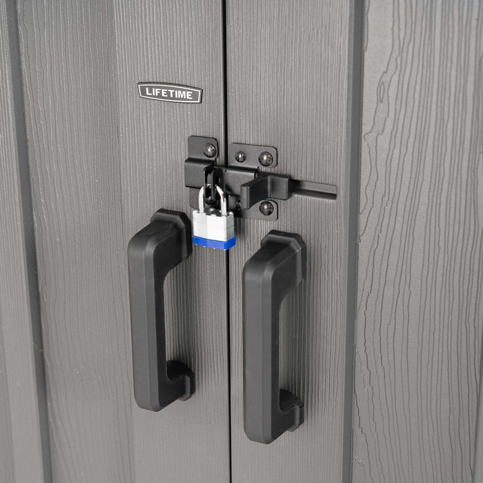 Close-up of Lifetime Farmhouse Storage Shed 60542 double door handles with black metal hasp latch secured by a blue padlock on wood-grain gray door surface