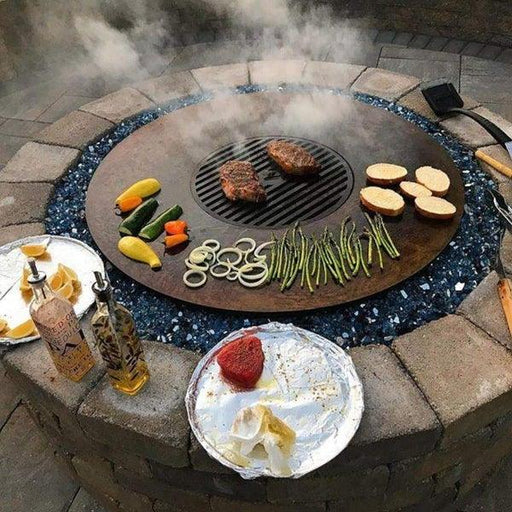 Sizzling barbecue on Arteflame Black Label 40" Fire Bowl Cooktop Grill, showcasing outdoor grilling at its finest.