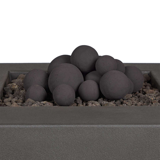Close-up of Real Flame 20-piece Outdoor Fire Pit Sphere Set arranged in a stacked configuration on lava rocks in a fire pit