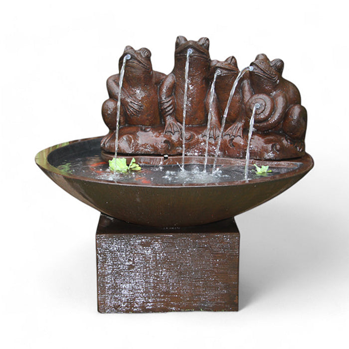 Frogs in the Pond Fountain, showing four frogs with water streams coming from their mouths, set in a dark brown, round basin with water and a couple of floating leaves. The fountain rests on a square pedestal.