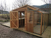 front and side view of the Alton Cedar Fusion Greenhouse with closed doors, emphasizing its wooden and glass craftsmanship.