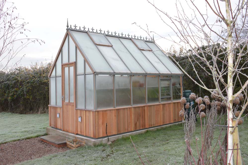 frosted panels on Alton Cedar Cheltenham Victorian Greenhouse in a wintry setting.