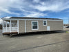 Full-length side view of the Champion Home no Loft by Oasis Tiny Estates, illustrating its compact design and mobility features.