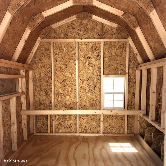 Interior photo of Little Cottage Co. 6x8 Gambrel Barn Coop showing wooden nesting box dividers and unfinished OSB wall panels.