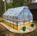 Outdoor Living Today Garden in a Box 8x12 with Greenhouse cover over a western red cedar raised bed on a stone-edged gravel pad by the woods