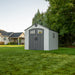 Closed view of a Lifetime 8x10 Shed in a garden, illustrating the shed's design and compatibility with outdoor spaces.