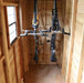 Interior of GardenSaver 12x4 Western Red Cedar Shed featuring mounted bicycles and spacious wood panel walls for storage.