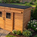 Side angle view of the Outdoor Living Today GardenSaver 12x4 shed showing its sliding doors and wood frame construction.