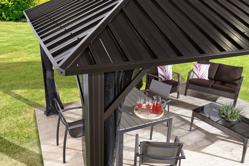 Corner view of Sojag Genova Gazebo roof with outdoor furniture underneath