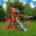 Multiple kids playing on the Gorilla Playsets Nantucket II with grey wave slide, swings, rock wall, sandbox, and two-story treehouse in backyard
