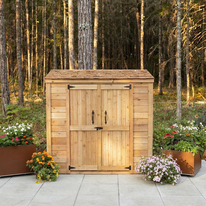Side angle view of the Grand Garden Chalet 6x3 shed showcasing its cedar siding and peaked roof design.